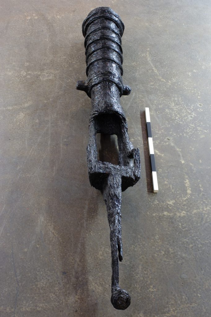 Black iron chambered swivel gun sitting on the concrete floor at the Charlestown Shipwreck Museum