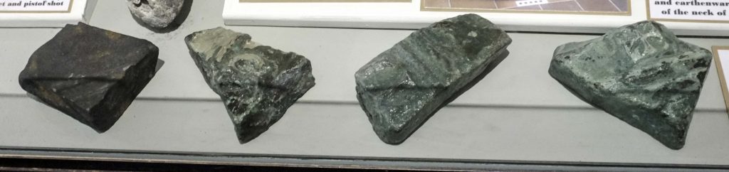 Fragments of bronze bell in a display case